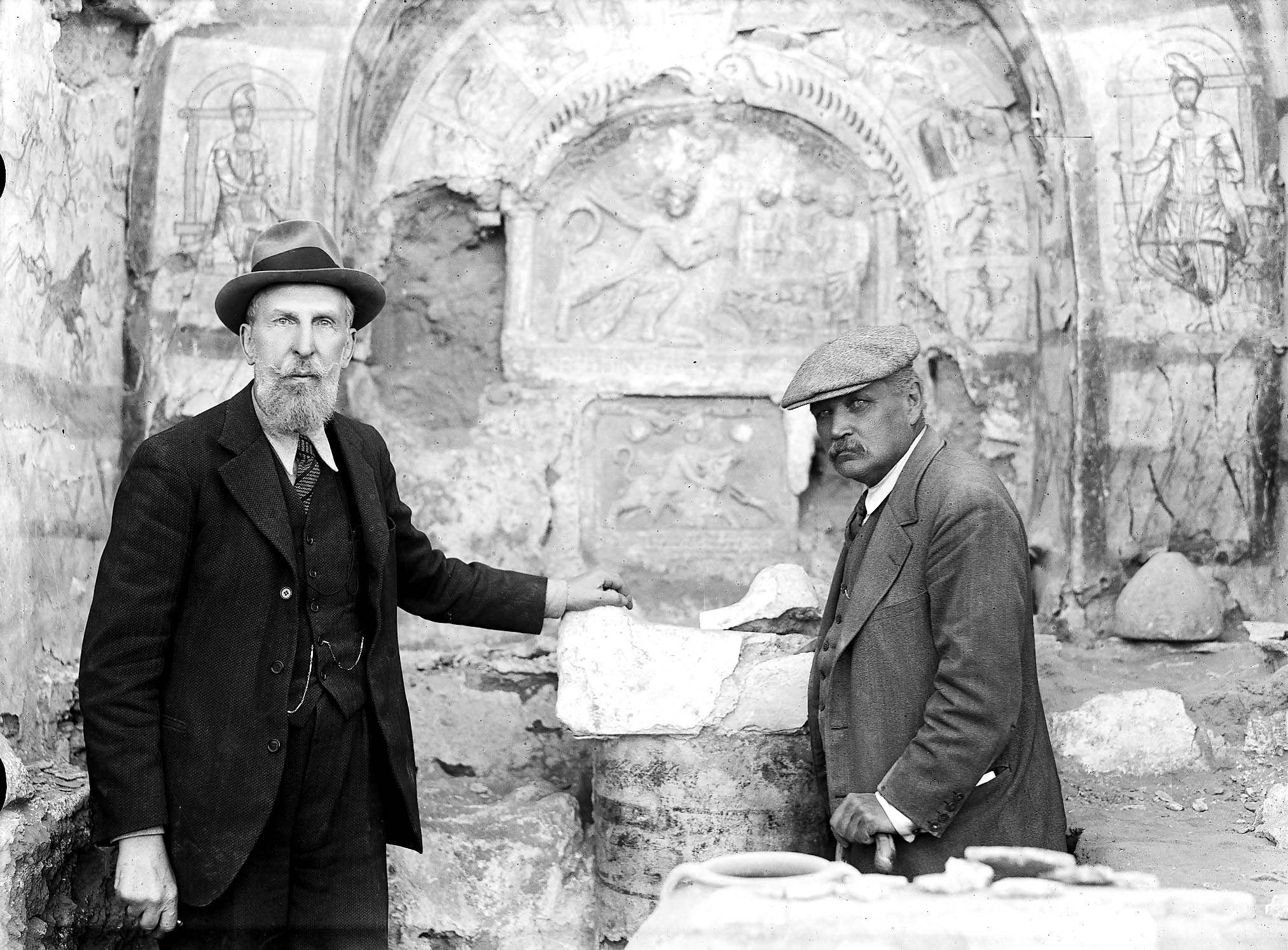 Franz Cumont poses in front of the main altar at the Mithraeum of Dura Europos