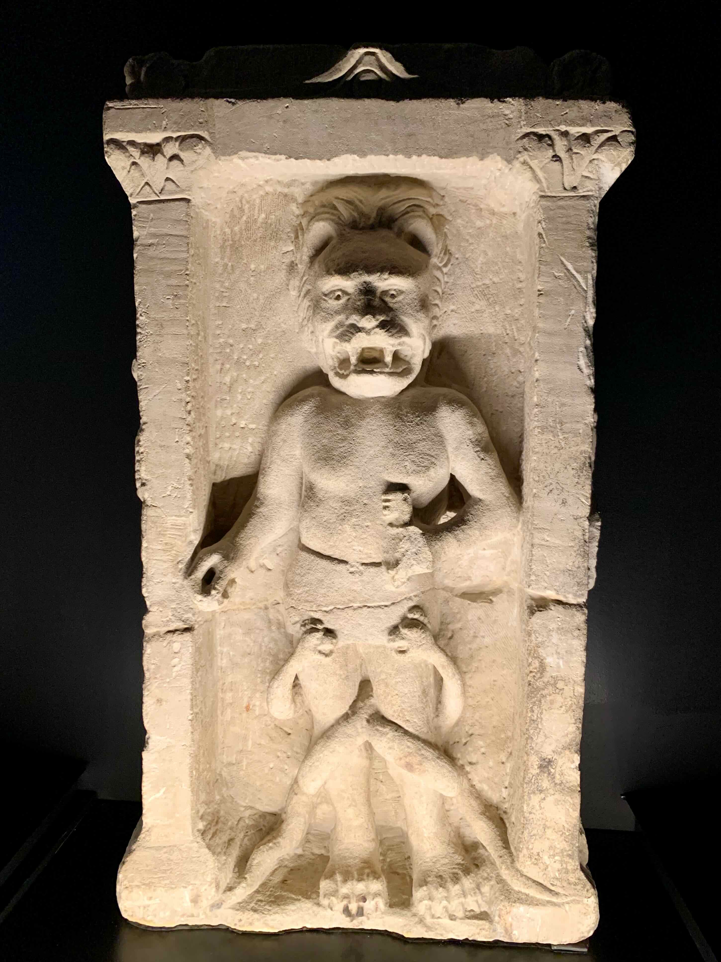 Limestone altar with lion-headed figure.