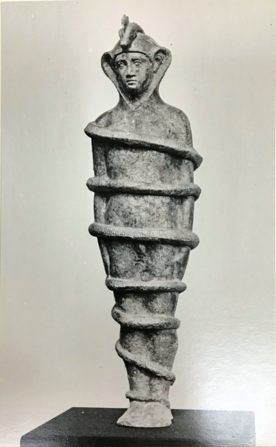 Human figure bound by a serpent nailed around his body.