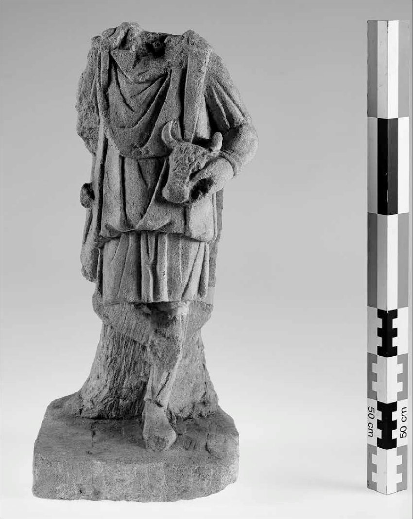 Statue of Cautes from Bodobrica, discovered around 1940, depicting the torchbearer standing before a tree or rock and associated with a bucranium.