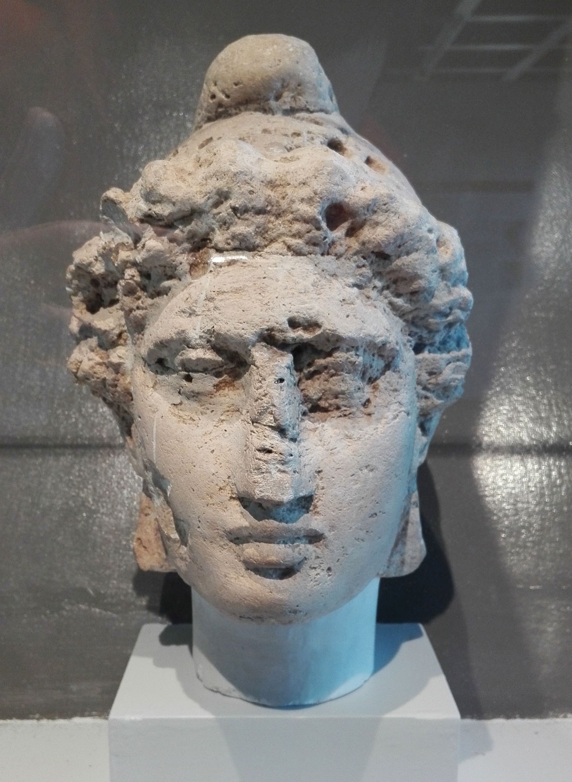 Head, possibly of Mithras, wearing a Phrygian cap, found in the bed of the Millicri River, near Locri, Calabria.